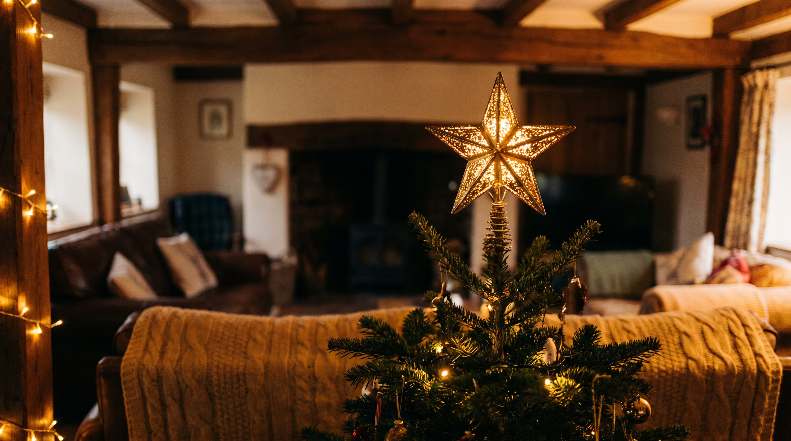 A metal star tree topper lit with warm lights